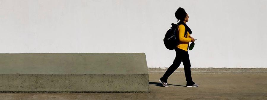 Woman walking along a path alone.